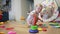 Baby plays with pyramid toy. happy family a kid dream concept. Baby plays pyramid with mugs in the playroom at home