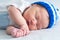 Baby portrait , sleeping newborn in hat on white blanket