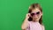 Baby posing for video cameras with glasses. Green screen