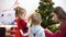 Baby and pregnan mom hang red ball toy on Christmas tree. happy childhood concept. child and mother decorate tree with