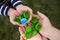 Baby puts plastic lids in mother`s hands. parent and his child collect cover. recyclable.