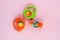 Baby rattles on pink background. Plastic toys for infants.