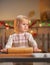 Baby rolling pin dough in christmas decorated kitchen