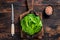 Baby romain green salad leaves in pan. Dark wooden background. Top view