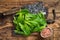 Baby romain green salad leaves on wooden cutting board. wooden background. Top view