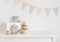 Baby room with wooden toys, plush animals and pennant garland