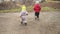 baby runing.Two little kids in grey jumpsuit yellow hat walking through forest park path. kid dream funny family concept