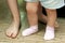 Baby`s first steps. Small and large feet close-up. Teach your child to walk. The concept of proper physical development of the