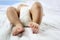 Baby\'s Foot of Asian Infant on a bed.