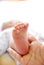 Baby\'s foot in a hand