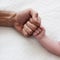 Baby`s hand with father`s hand. little infant`s hand. baby with dad