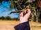 Baby`s hand picks olives from the plant