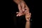 A baby`s hands holding tightly A senior man`s old age finger. Family, Generation, Support and people concept.