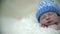 Baby\'s head with blue hat