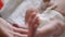 A baby`s little foot in the mother`s hand. Tiny newborn baby