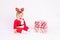 Baby in Santa costume with gifts on white isolated background crying, new year and Christmas concept