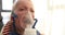 Baby screaming crying in nebulizer mask vapor