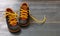 Baby shoes on wood, closeup view, child booties blue and yellow color