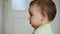 The baby side shot close-up portrait, serious concentrated toddler, listening to mother