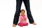 Baby sitting beneath mommy\'s legs