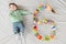 Baby six months top view. Happy baby in a hat and a diaper lying on the background of the carpet, smiling baby Toddler in a shirt