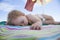 Baby sleeping on beach towel