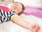 Baby sleeps in parents bed. arms outstretched baby`s restful sleep. close-up. child 0-1 years old. adorable lovely baby sleeps