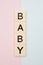 Baby spelled out in tan tiles