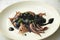Baby squid in its black ink. Traditional Spanish tapa recipe.