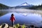 A baby standing infront of trillium lake