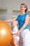 Baby standing at Physiotherapy beside a Fitness Ball