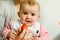 Baby starting by tasting a strawberry using the Baby led weaning BLW method