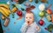 Baby surrounded with fruits and vegetables