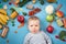 Baby surrounded with fruits and vegetables