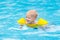 Baby in swimming pool. Kids swim