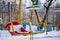 Baby swings at a playground blanketed with clean snow on a winter day in the city park