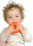 Baby teething on orange plastic ring