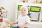 Baby toddler boy playing with busy board and teddy bear at home. Developing games for children.