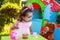 Baby toddler girl playing in outdoor tea party talking, chatting or sharing to her best friend Teddy Bear