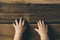 Baby toddler hand on a wooden table