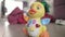 Baby toy duck moving on floor. Musical toy with button and lights moving