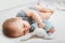 Baby with toy in hands sleeps on bed. Infant development concept, toddler restful sleep, teething, colic