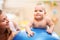 Baby training with gymnastic ball with mother at home.