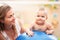 Baby training with gymnastic ball with mother at home.