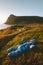 Baby traveler laying on moss relaxing with mountains and sea view