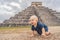 Baby traveler, tourists observing the old pyramid and temple of the castle of the Mayan architecture known as Chichen