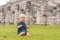 Baby traveler, tourists observing the old pyramid and temple of the castle of the Mayan architecture known as Chichen