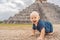 Baby traveler, tourists observing the old pyramid and temple of the castle of the Mayan architecture known as Chichen