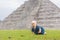 Baby traveler, tourists observing the old pyramid and temple of the castle of the Mayan architecture known as Chichen