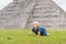 Baby traveler, tourists observing the old pyramid and temple of the castle of the Mayan architecture known as Chichen